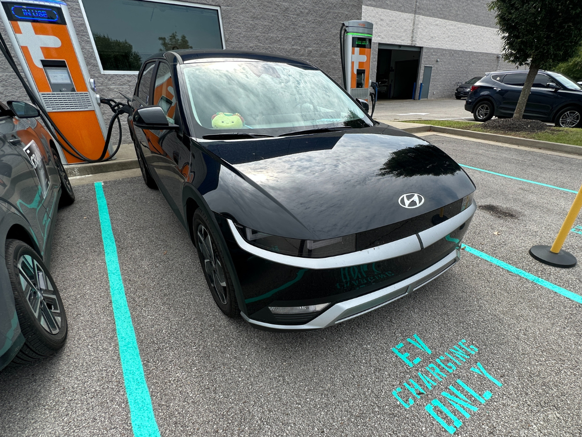 2025 Hyundai Ioniq 5 charging at a Tesla Supercharger station in Fayetteville, Arkansas.